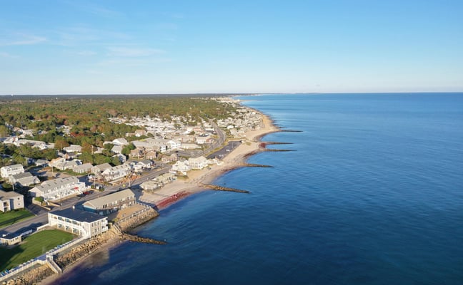 Aerial view of a Cape Cod town along the Nantucket Sound shoreline on a clear autumn day