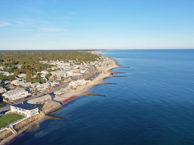 Aerial view of Cape Cod coastline showing resort community homes along the shore
